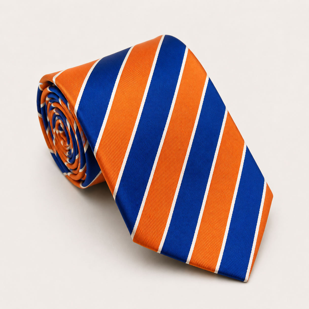 A rolled George Neale blue and orange stripe silk tie.