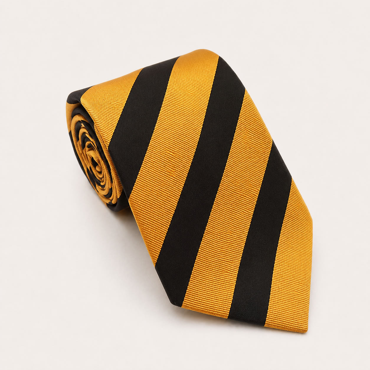 A rolled George Neale gold and black stripe silk tie.