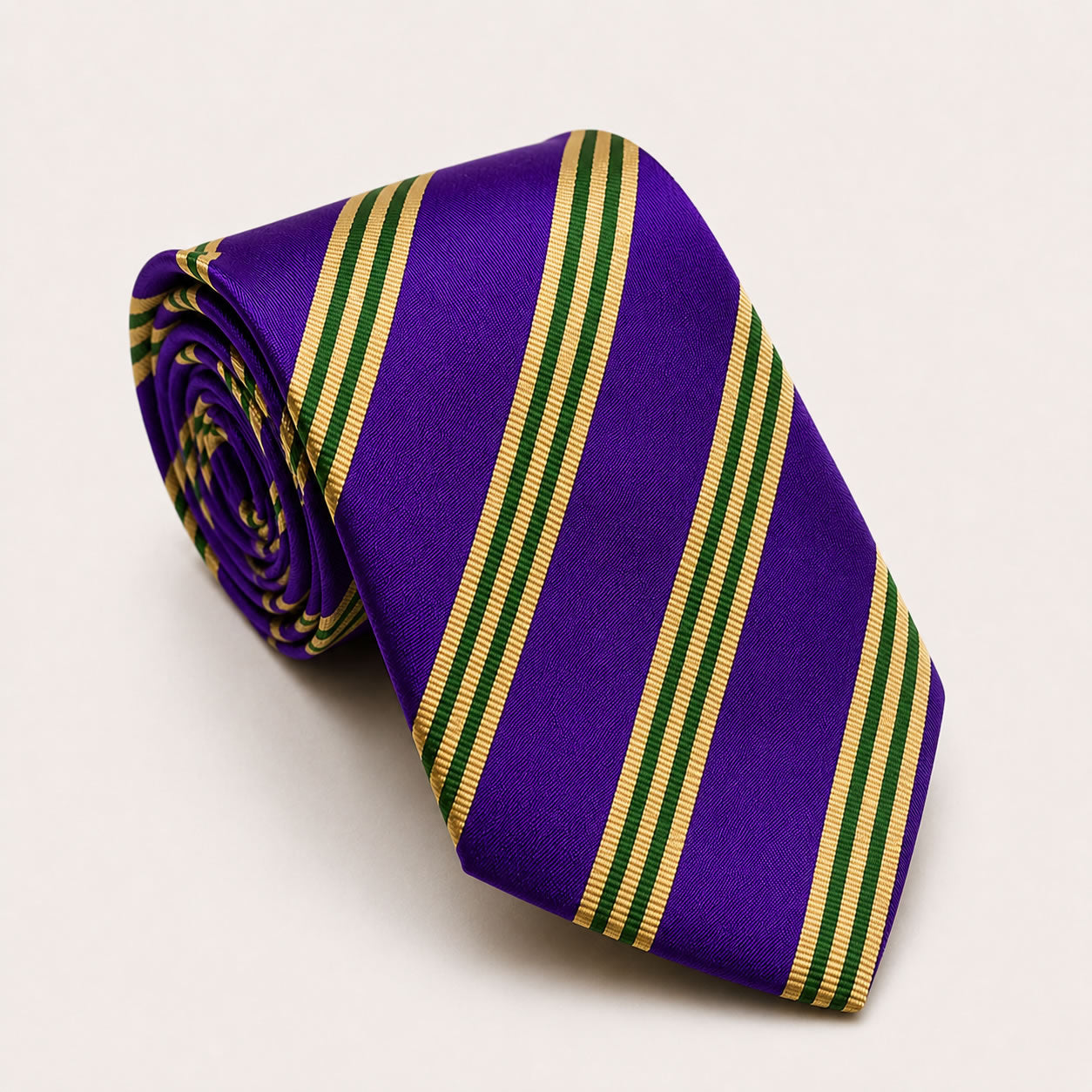 A rolled George Neale purple and green stripe silk tie.