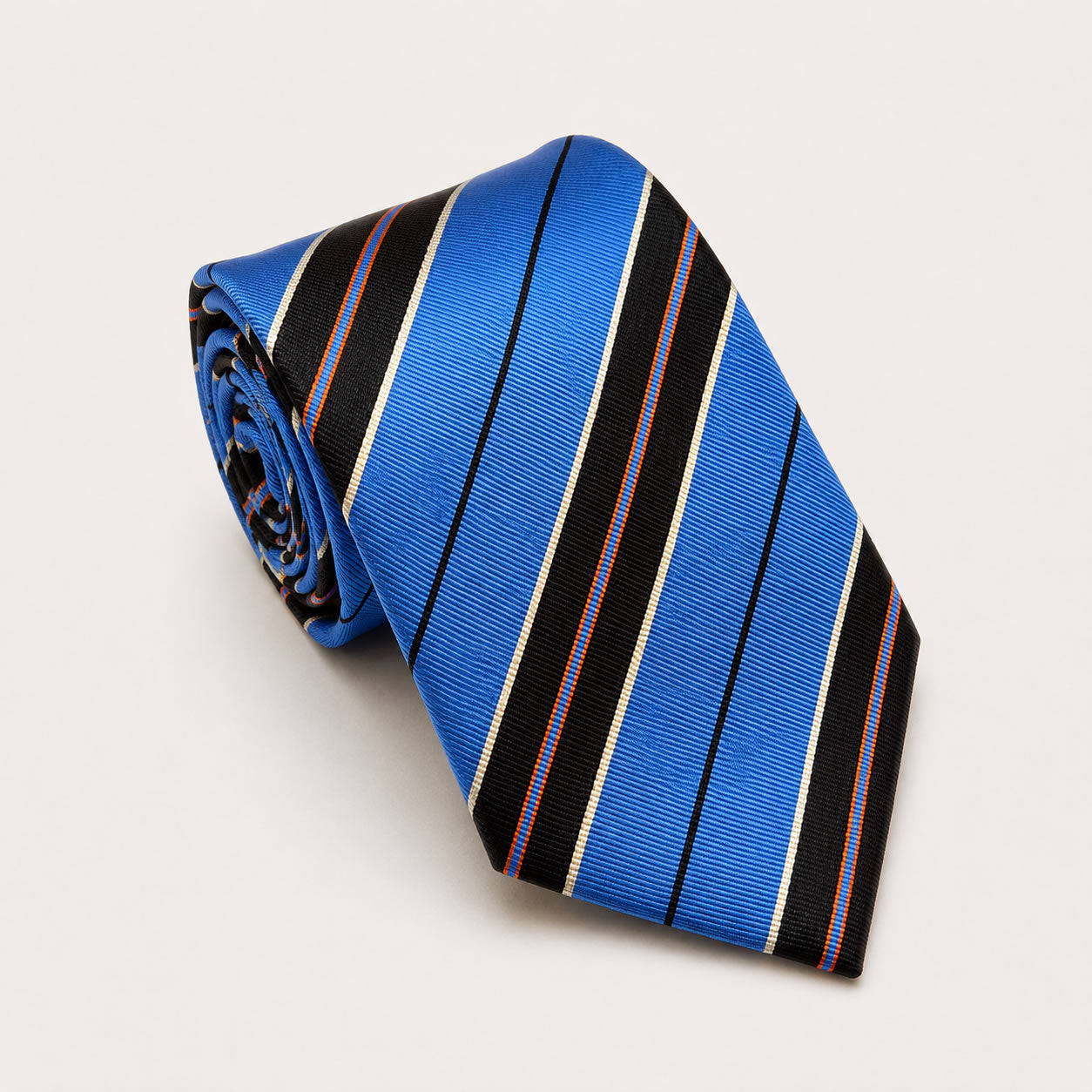 A rolled George Neale blue and black stripe silk tie.