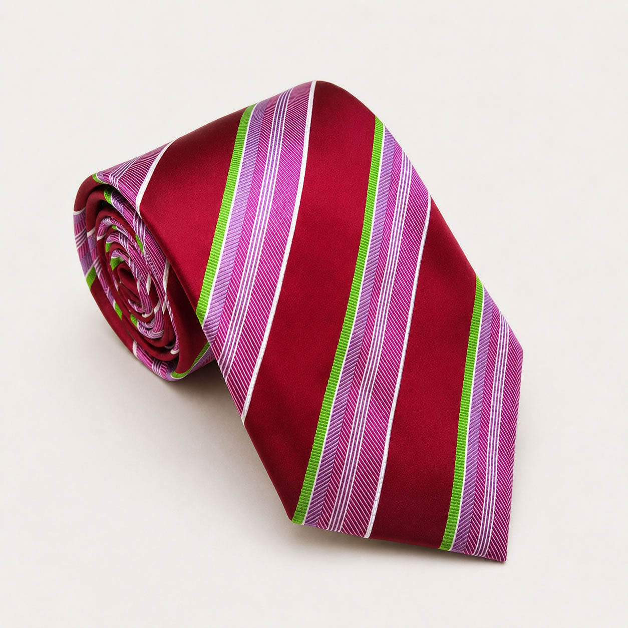 A rolled George Neale red and pink stripe silk tie.