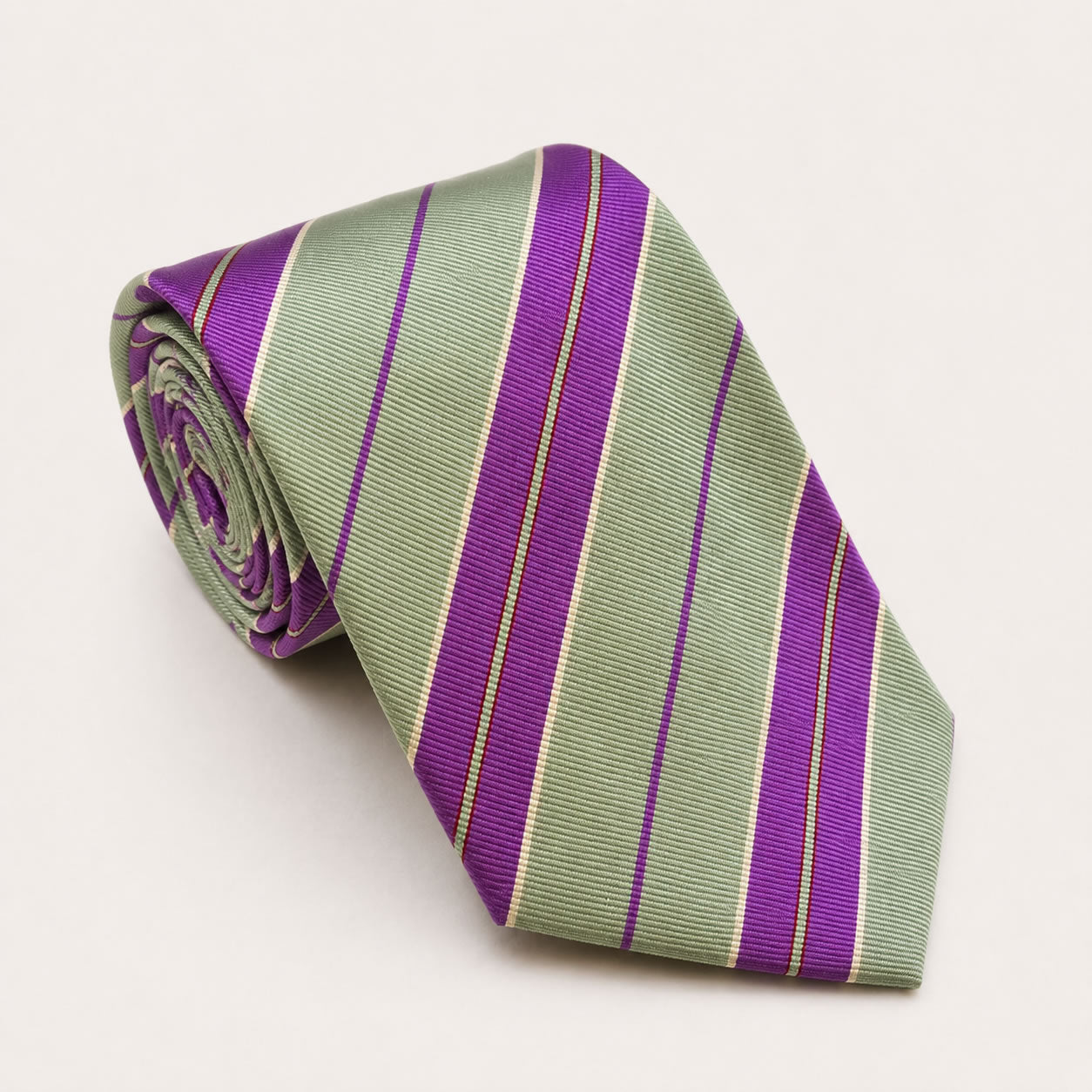 A rolled George Neale sage green and purple stripe silk tie.