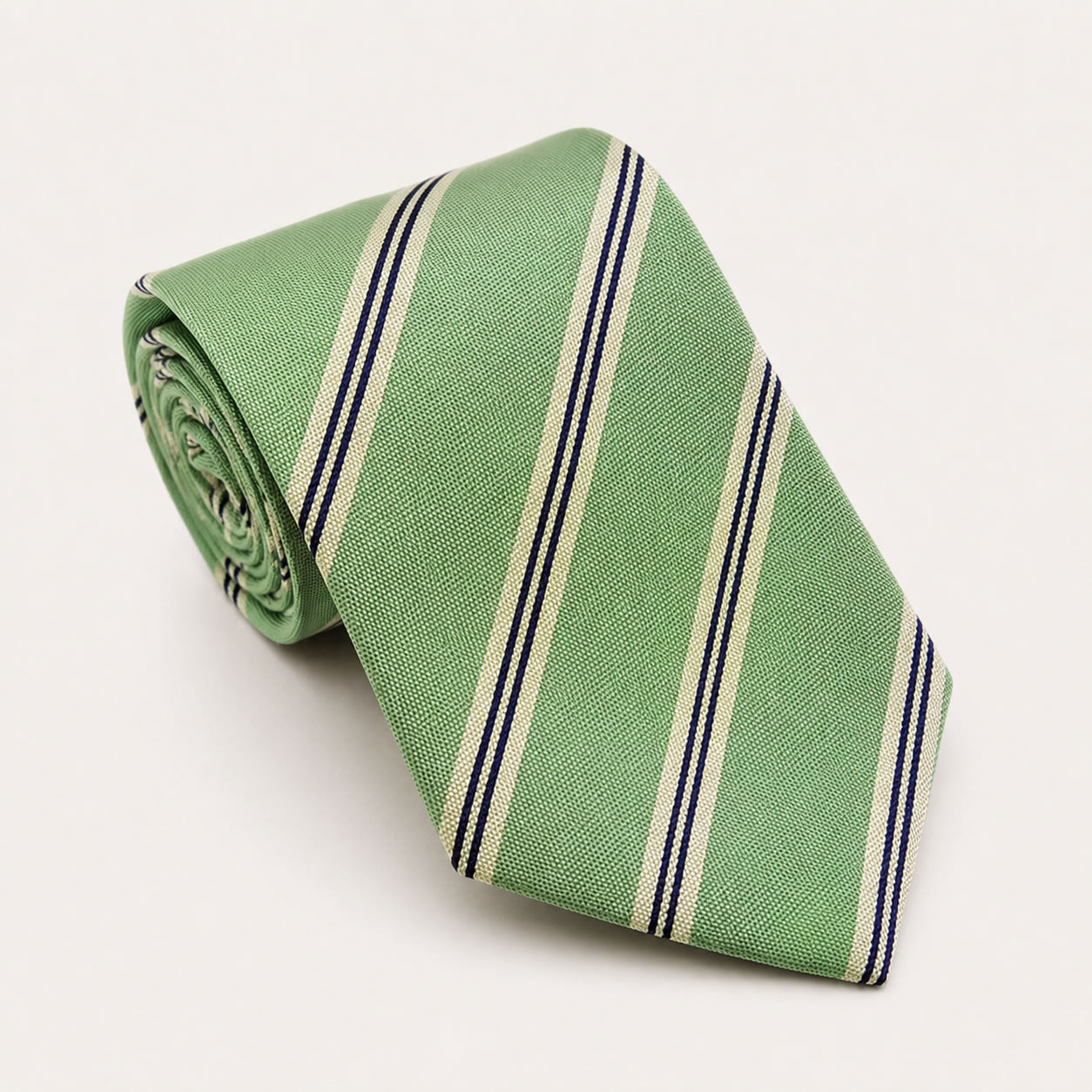 A rolled George Neale sage green stripe silk tie.