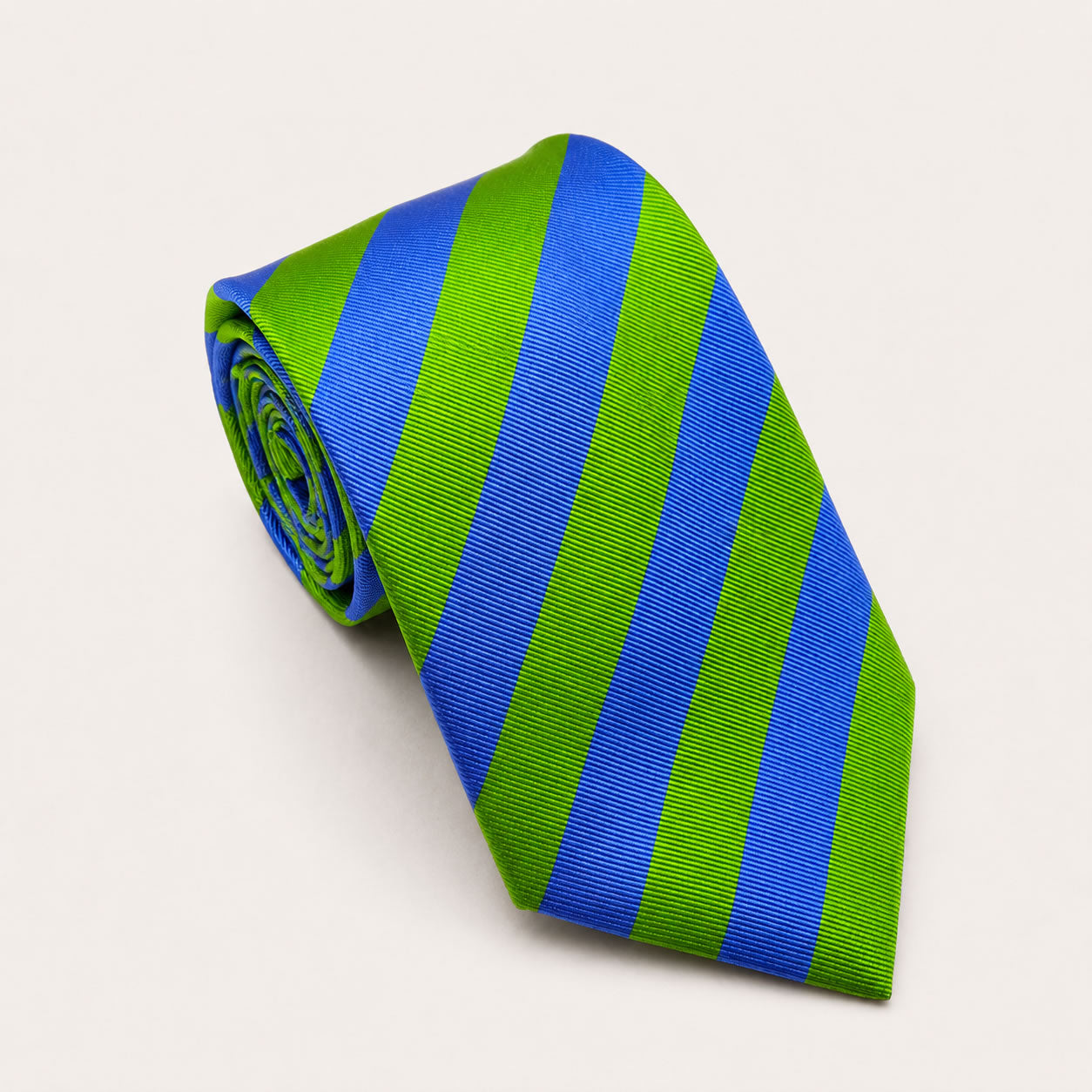 A rolled George Neale green and blue stripe silk tie.