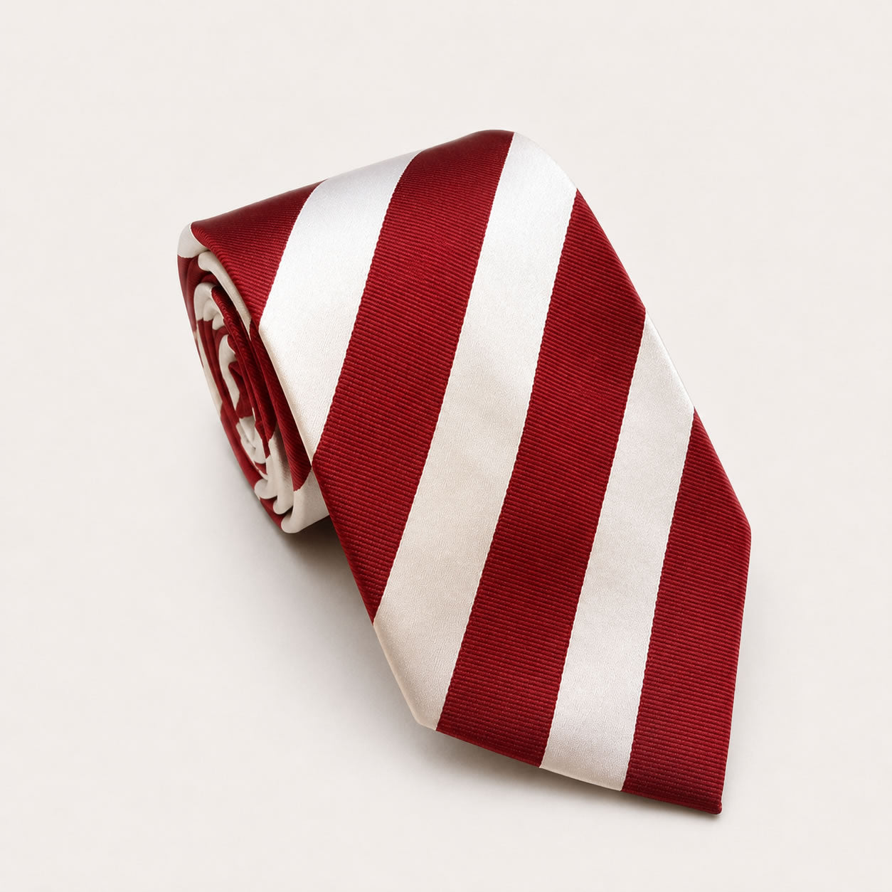 A rolled George Neale burgundy and white stripe silk tie.