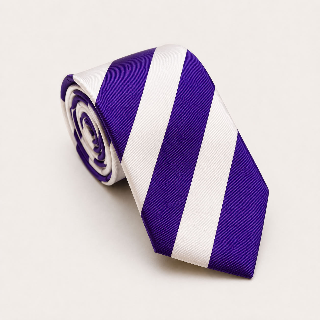 A rolled George Neale purple and white stripe silk tie.