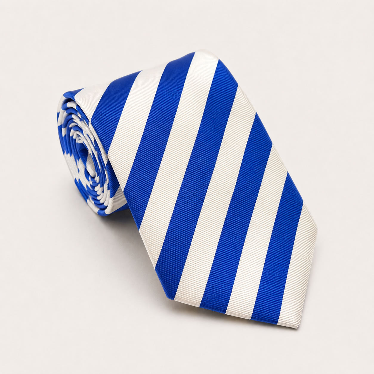 A rolled George Neale blue and white stripe silk tie.