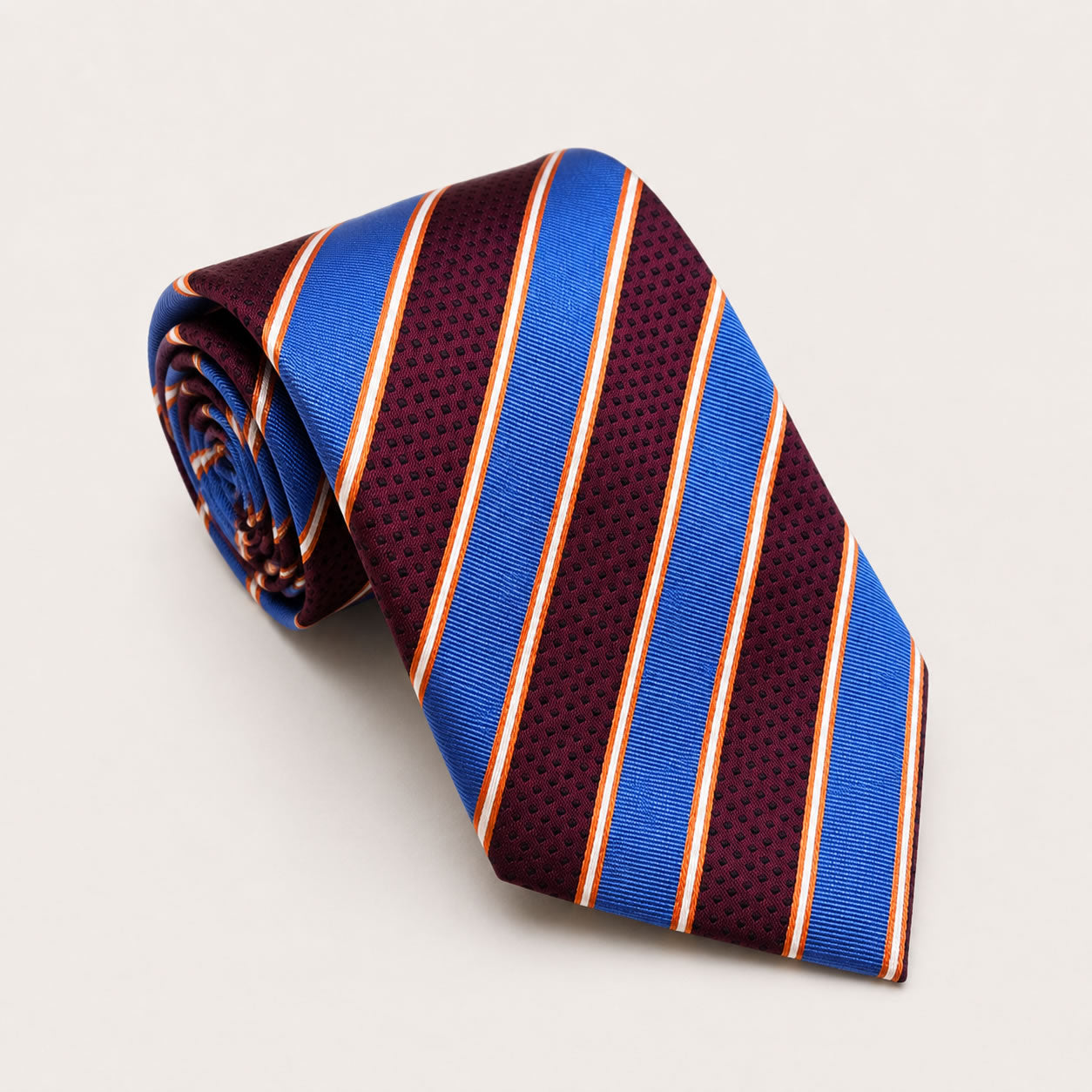 A rolled George Neale maroon and blue stripe silk tie.