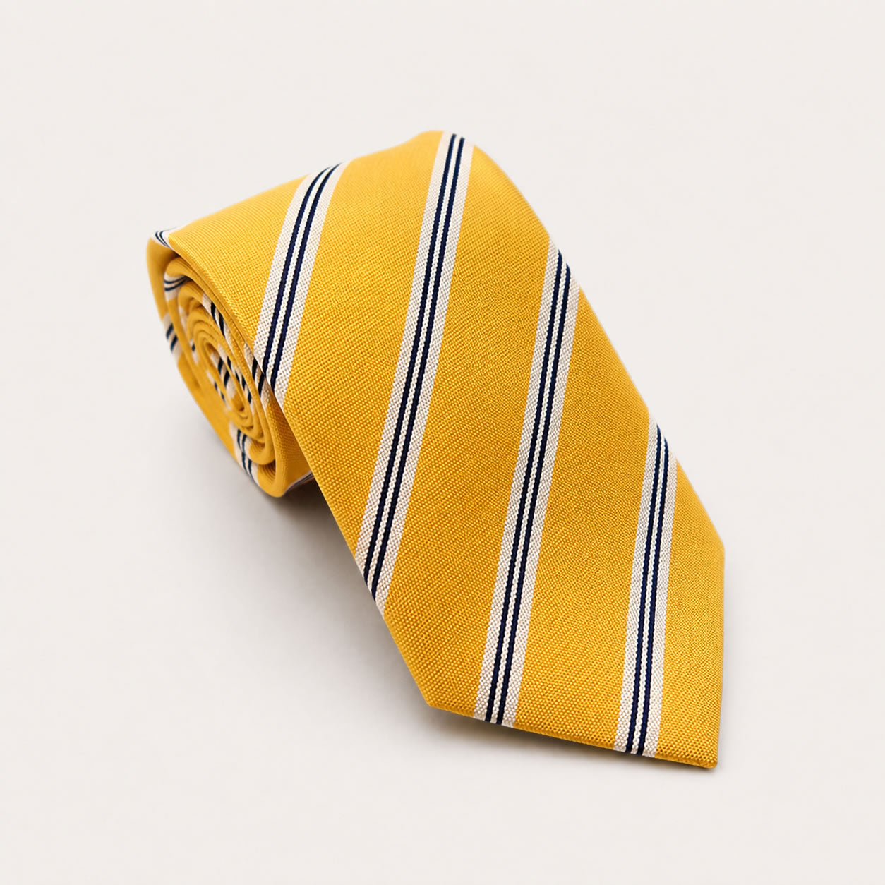 A rolled George Neale yellow stripe silk tie.